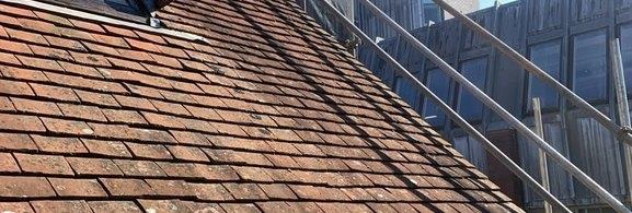 Edge protection along a pitched tiled roof